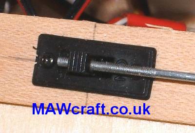 Screw in the 2mm threaded rod into the 2mm hole you just drilled in the switch arm